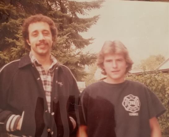A man standing next to another man