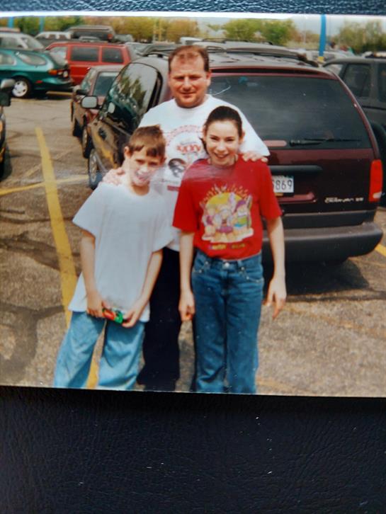 A man and two children posing for a picture