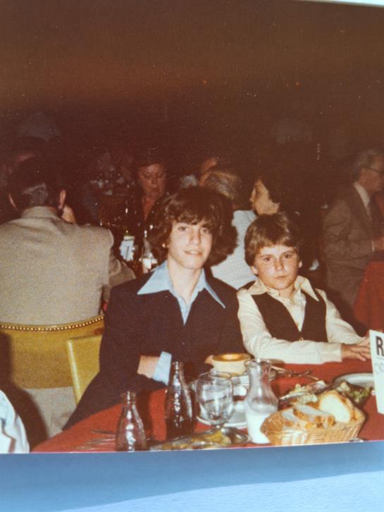 A man and boy sitting at a table