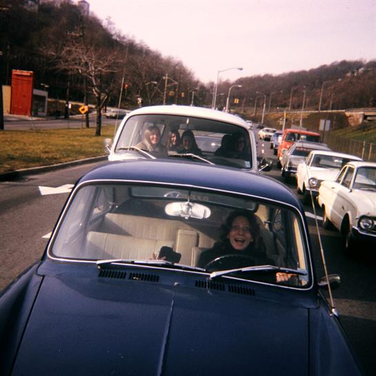 A group of people driving a car
