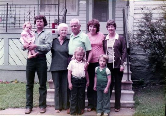 A group of people standing outside a house