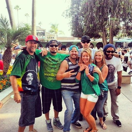 Friends in festive attire enjoy fun times at a lively music festival.