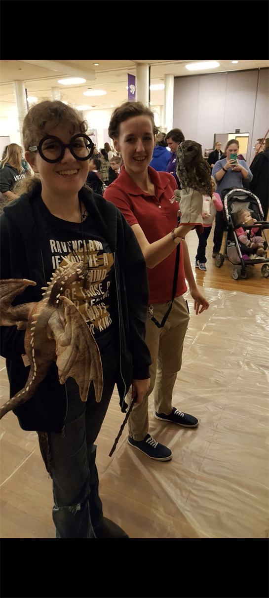 A woman holding an owl