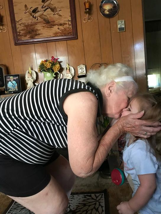 A woman kissing a girl