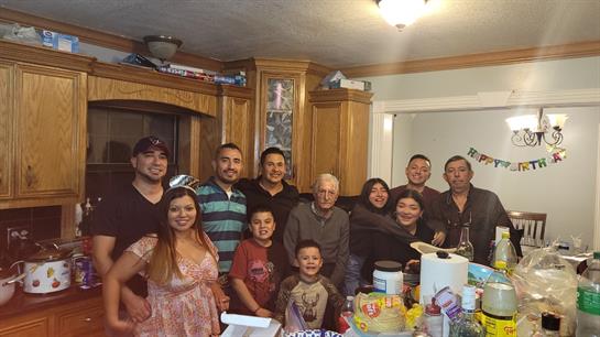 A cheerful family comes together in a warm kitchen, enjoying a festive holiday celebration.