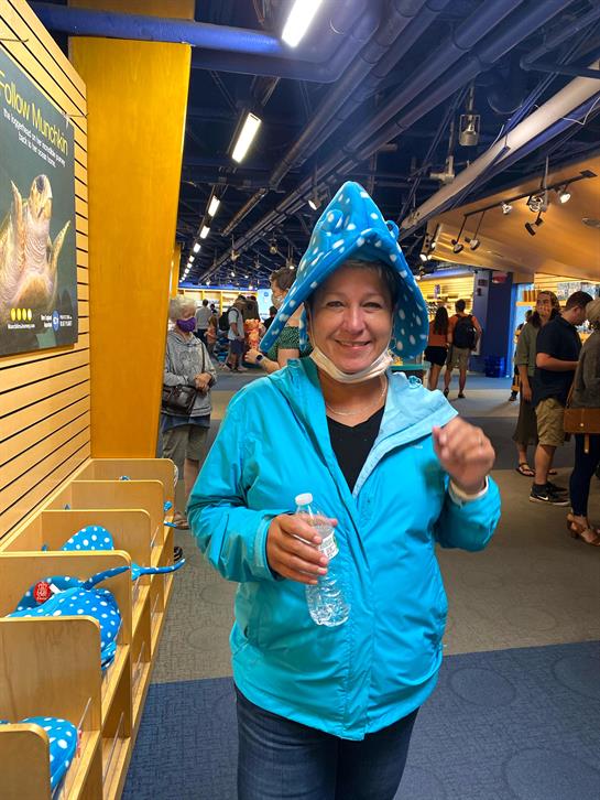 A woman wearing a blue jacket and a blue hat