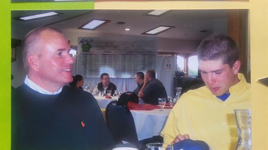 Group of people enjoying each other's company while seated in a cozy restaurant setting.