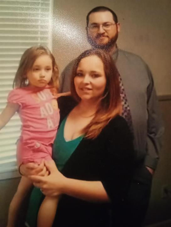 A man and woman holding a child