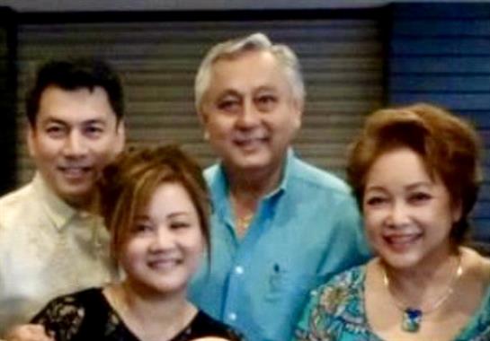 Friends enjoy each other's company, sharing smiles and laughter at a family gathering indoors.