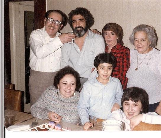 A warm family gathering showcases joyful moments with multiple generations at a cozy dinner table.