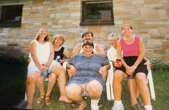 A group of people sitting on lawn chairs
