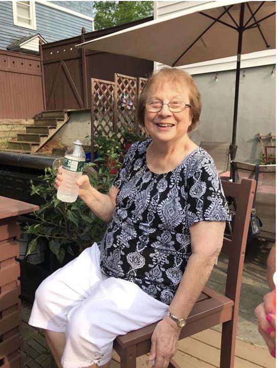 A woman sitting on a bench holding a bottle of water