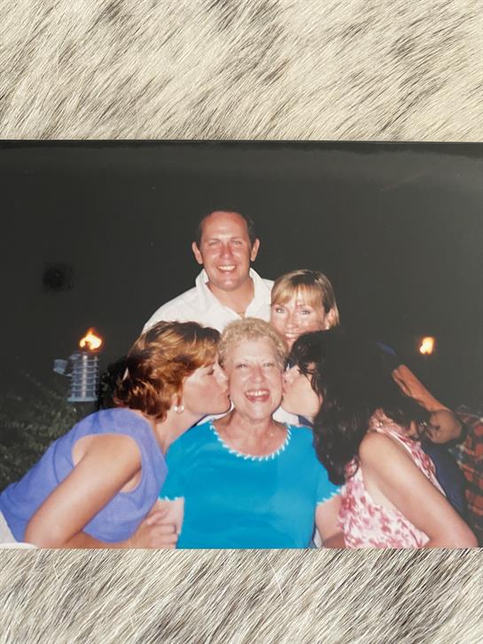 A joyful family gathering unfolds on the beach, full of love and laughter.