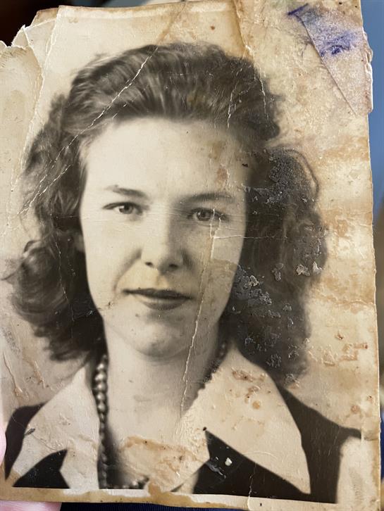 A woman with curly hair and a necklace
