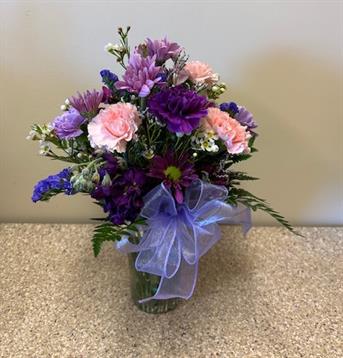 A bouquet of flowers in a glass vase