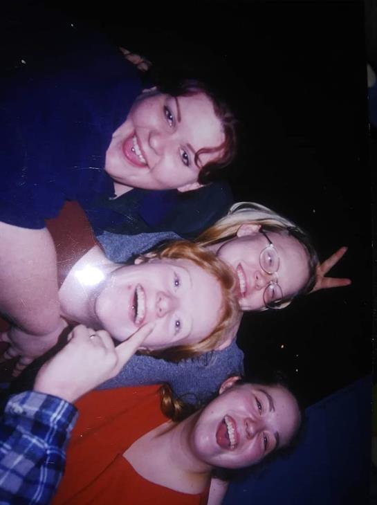 Four friends share joyful moments during a social gathering, showcasing vibrant expressions.