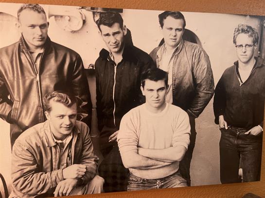 A group of men posing for a photo