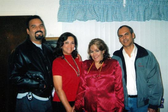 Friends smile and enjoy each other's company in a comfortable, welcoming indoor environment.