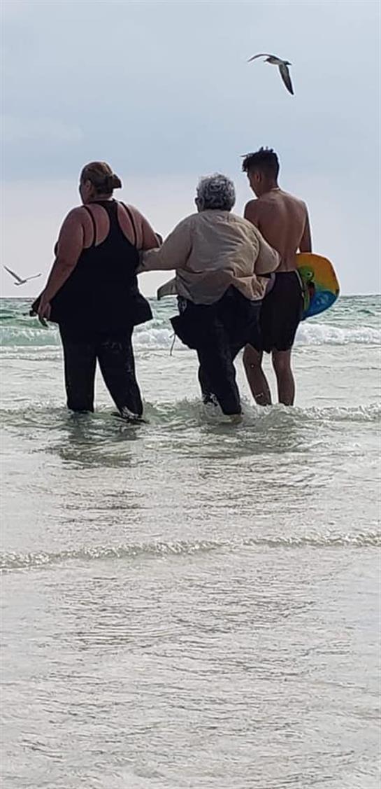 A group of people standing in the water