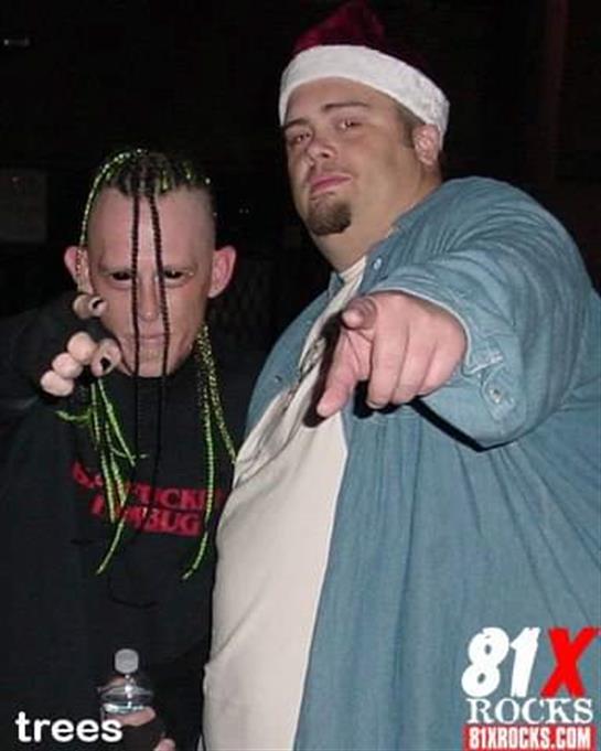 Two people strike a pose at a casual gathering, showcasing their unique styles and expressions.