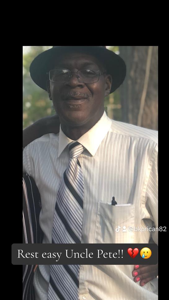 A man wearing a hat and tie