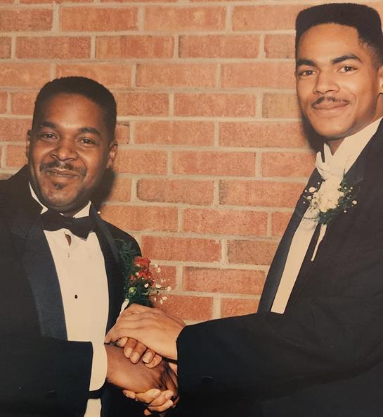 Two men in suits holding hands