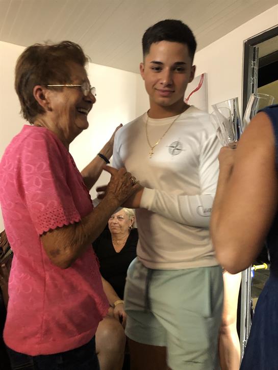 Family members share joyful moments while celebrating together in a cozy living room.