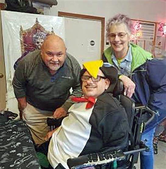 Three friends gather in a warm environment, sharing joy and laughter during a celebration.