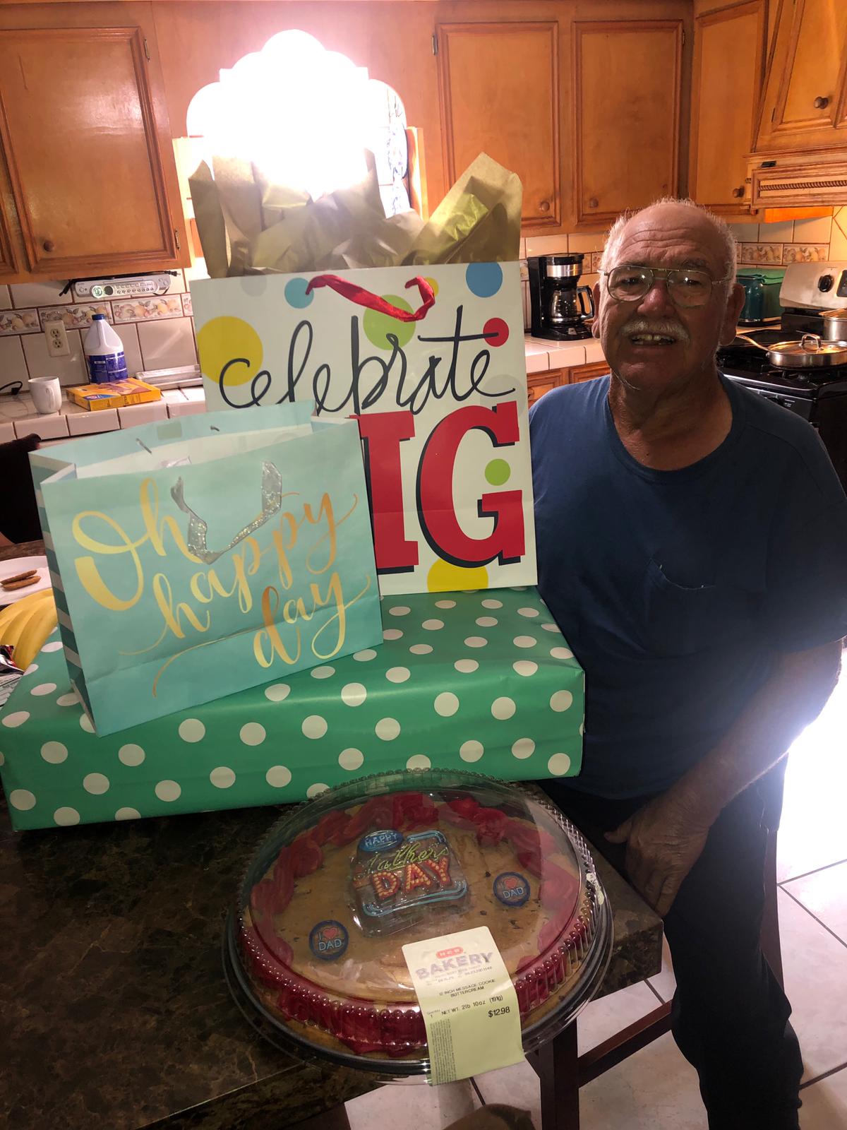 A man standing next to a pile of presents