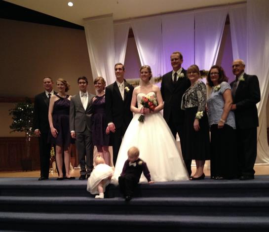 Friends and family gather to capture a joyful moment after a wedding ceremony.
