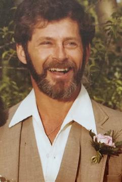 A man with a beard smiling