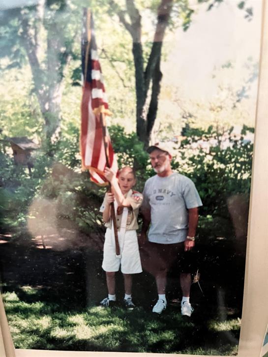 A man and boy holding a flag