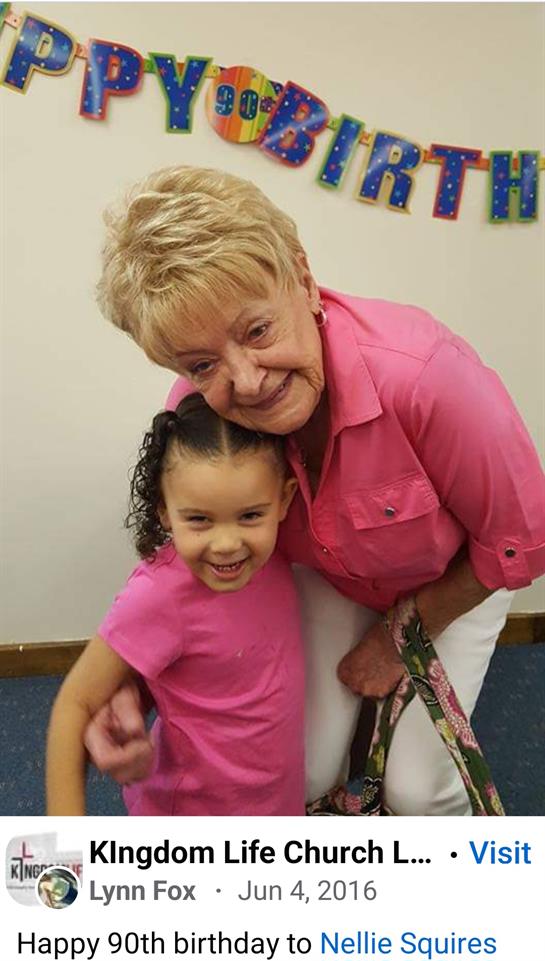 A joyful moment shared between a grandmother and granddaughter during a birthday celebration.