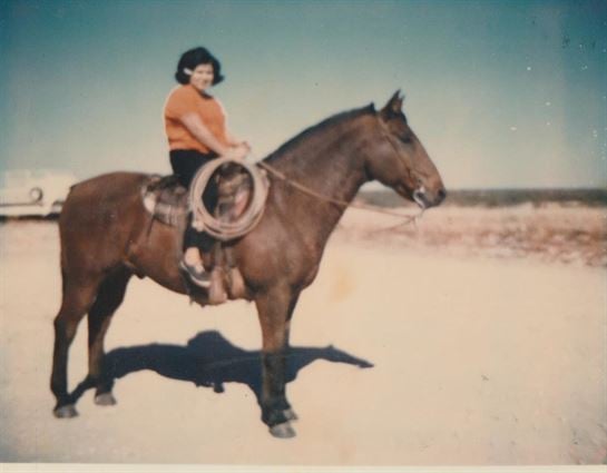 A woman riding a horse