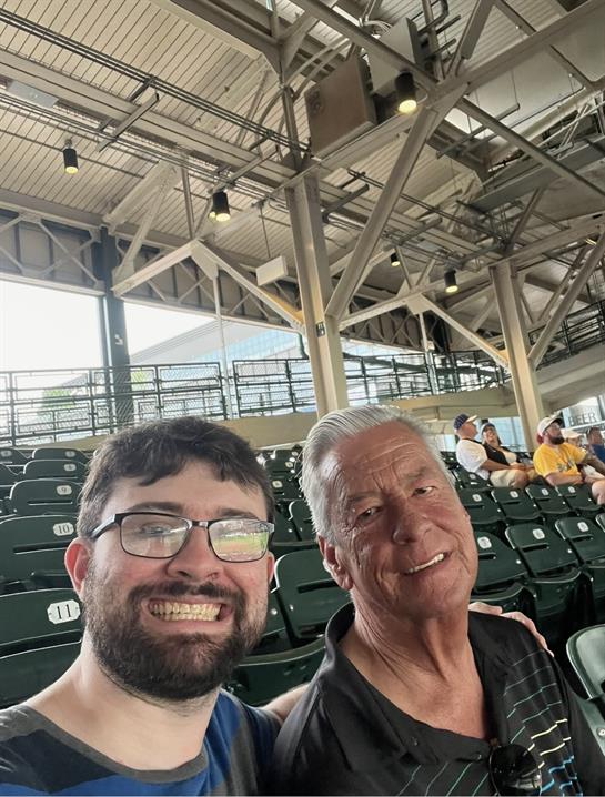 Two men sitting in a stadium
