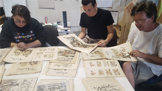 A group of men sitting at a table looking at a piece of paper