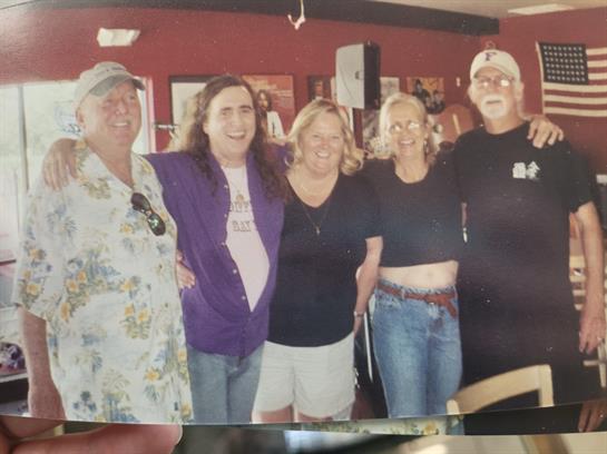 Friends celebrate their connection at a casual restaurant gathering in the daytime.