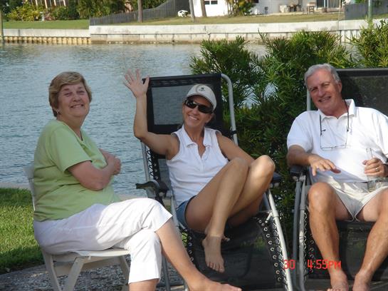 A group of people sitting in chairs by water