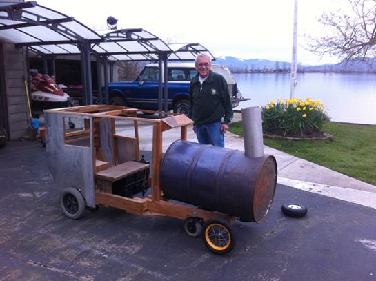 A man standing next to a small train