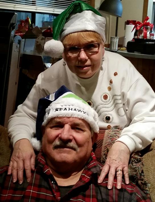 A woman and man wearing christmas hats