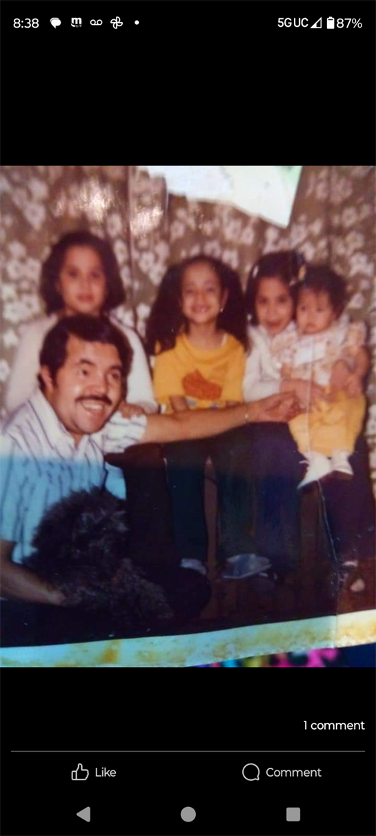 A man and two girls posing for a photo