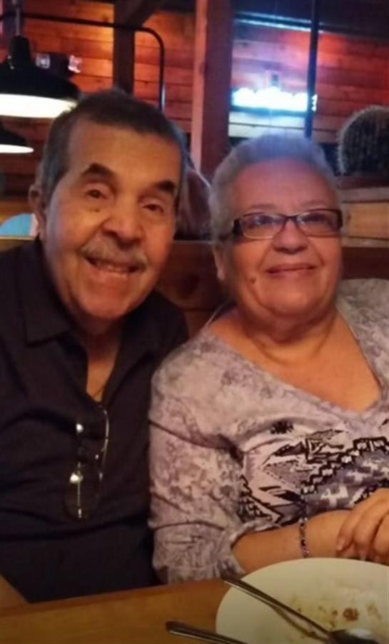 A man and woman sitting together smiling