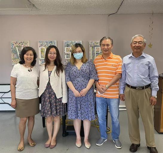 Friends gather at a community center, celebrating together and enjoying each other's company.