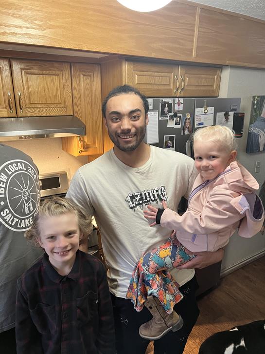 A man holding a child and smiling
