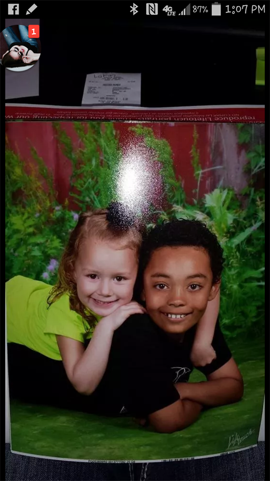 A boy and girl posing for a picture