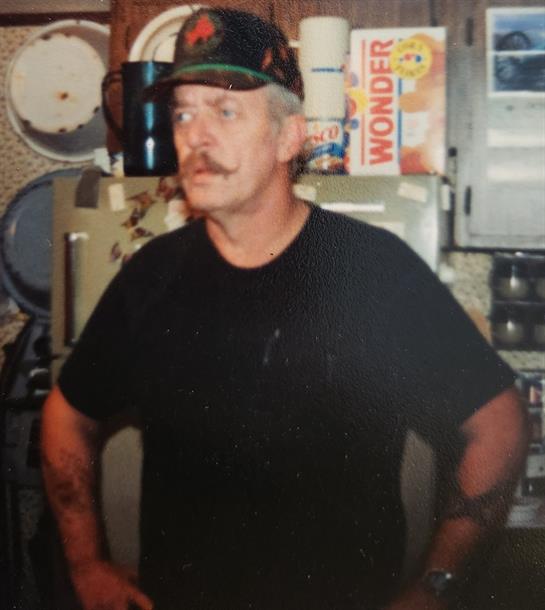 A man with a mustache wearing a hat