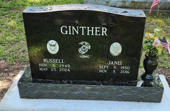 A grave stone with white text