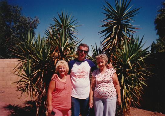 A group of people standing in front of a tree