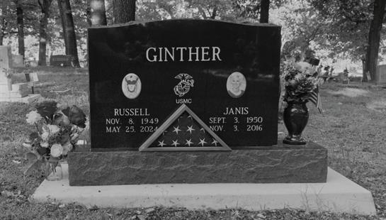 A grave stone with a flag and a flag