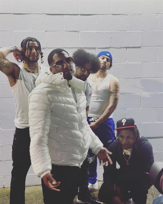 Five friends gathered outdoors at night, showcasing a relaxed atmosphere and casual clothing.